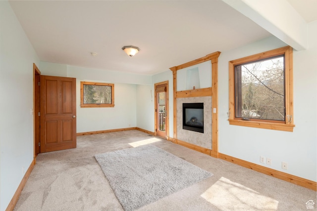 2003 Venus Ct, Park City, UT 84060 - unfurnished living room featuring carpet flooring, a tiled fireplace, and baseboards