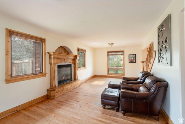 2003 Venus Ct, Park City, UT 84060 - living room featuring light wood-style floors, a glass covered fireplace, baseboards, and stairs