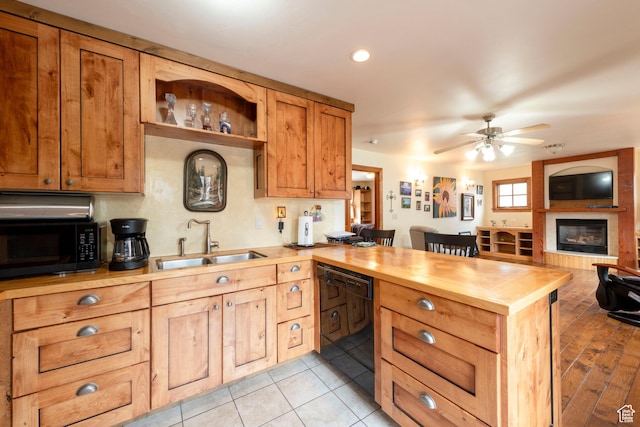 2003 Venus Ct, Park City, UT 84060 - kitchen with black appliances, a sink, a peninsula, butcher block countertops, and a ceiling fan