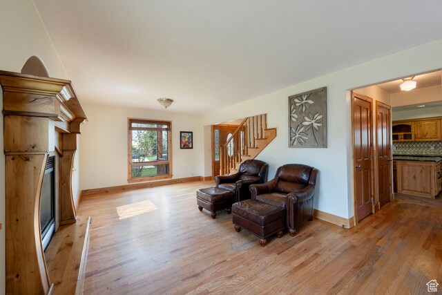 2003 Venus Ct, Park City, UT 84060 - living area with a glass covered fireplace, light wood finished floors, stairs, and baseboards