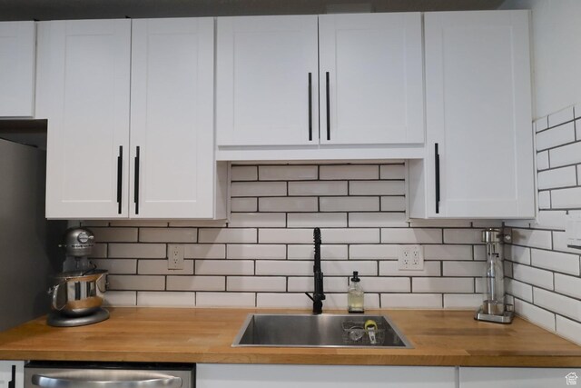 1834 E Cloverdale Rd S, Cottonwood Heights, UT 84121 - kitchen featuring wooden counters, white cabinetry, backsplash, and stainless steel dishwasher