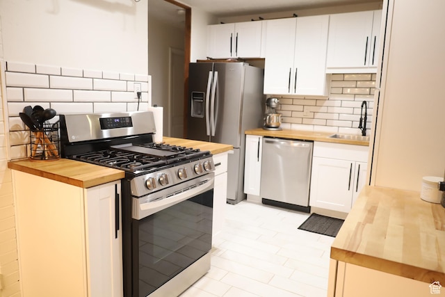 1834 E Cloverdale Rd S, Cottonwood Heights, UT 84121 - kitchen featuring wooden counters, stainless steel appliances, a sink, and backsplash