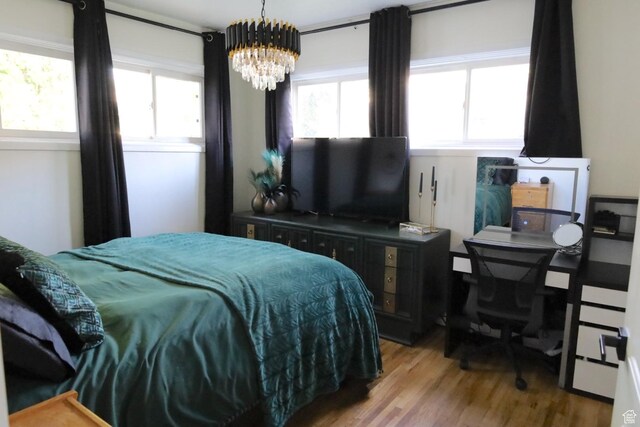1834 E Cloverdale Rd S, Cottonwood Heights, UT 84121 - bedroom featuring wood finished floors and a chandelier