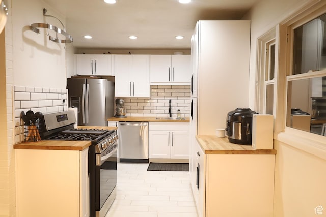 1834 E Cloverdale Rd S, Cottonwood Heights, UT 84121 - kitchen featuring butcher block countertops, appliances with stainless steel finishes, recessed lighting, a sink, and white cabinetry