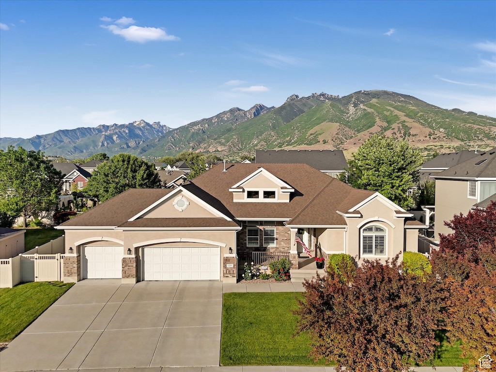 13281 S Wilburton Dr, Draper, UT 84020 - view of front of property featuring a garage, driveway, stucco siding, a mountain view, and a gate