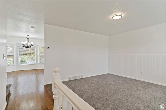 1134 N 2825 W, Layton, UT 84041 - unfurnished room with a chandelier, wood finished floors, a wainscoted wall, a textured ceiling, and baseboards
