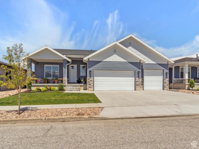 3222 W Harvard Dr, Mountain Green, UT 84050 - craftsman-style house featuring an attached garage, a front yard, driveway, stone siding, and covered porch