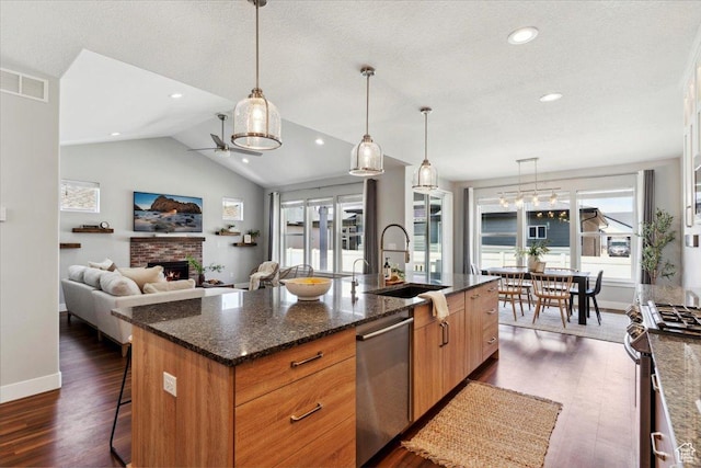 3222 W Harvard Dr, Mountain Green, UT 84050 - kitchen featuring stainless steel appliances, a sink, dark wood finished floors, an island with sink, and baseboards