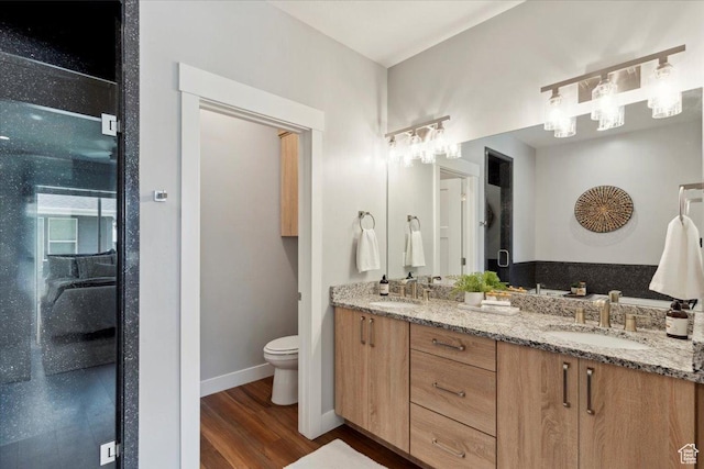 3222 W Harvard Dr, Mountain Green, UT 84050 - bathroom featuring double vanity, wood finished floors, toilet, and baseboards