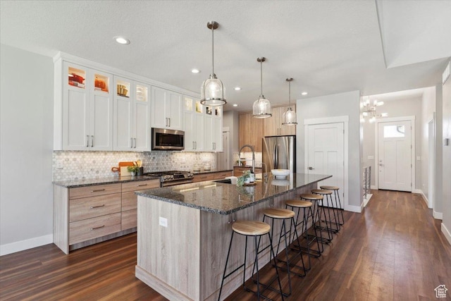3222 W Harvard Dr, Mountain Green, UT 84050 - kitchen featuring appliances with stainless steel finishes, a sink, baseboards, decorative backsplash, and dark wood finished floors