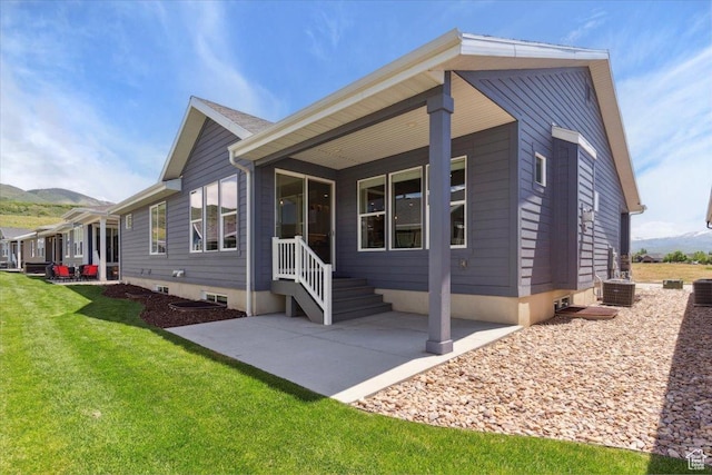 3222 W Harvard Dr, Mountain Green, UT 84050 - view of front facade with a mountain view, a front lawn, a patio area, and central AC unit
