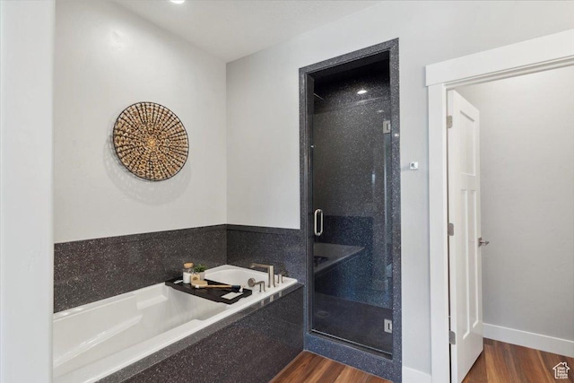 3222 W Harvard Dr, Mountain Green, UT 84050 - full bathroom featuring wood finished floors, a shower stall, and a garden tub