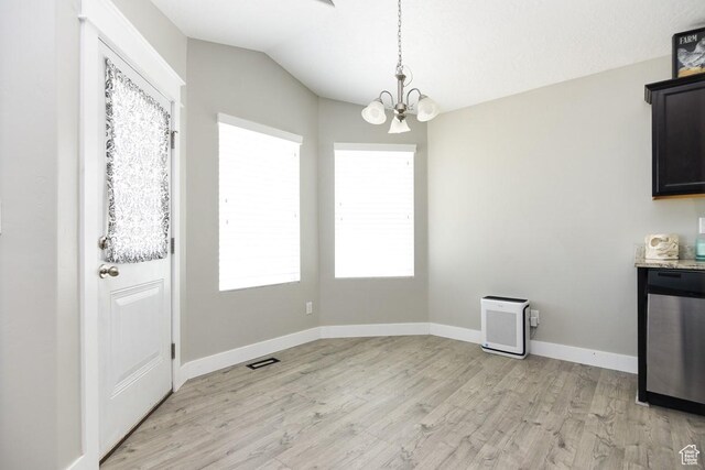 312 W 970 N, Tooele, UT 84074 - unfurnished dining area featuring a chandelier, light wood-style floors, lofted ceiling, and baseboards
