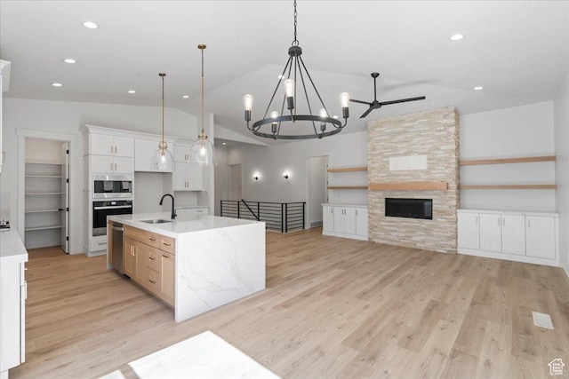 4721 S Taylors View Ln Unit 18, Taylorsville, UT 84123 - kitchen featuring open floor plan, a sink, appliances with stainless steel finishes, vaulted ceiling, and light wood-style flooring