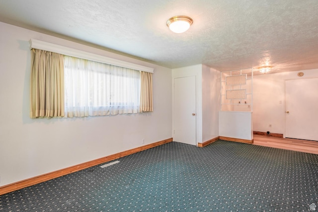 570 N Parkway Ave, Tooele, UT 84074 - carpeted spare room featuring baseboards and a textured ceiling
