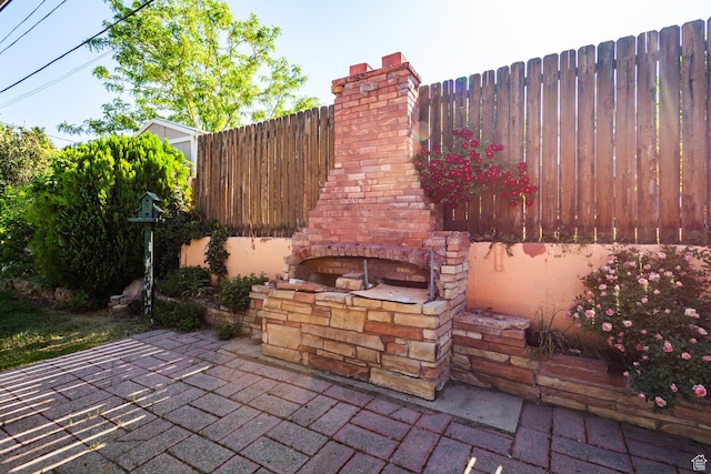 570 N Parkway Ave, Tooele, UT 84074 - view of patio / terrace with an outdoor brick fireplace