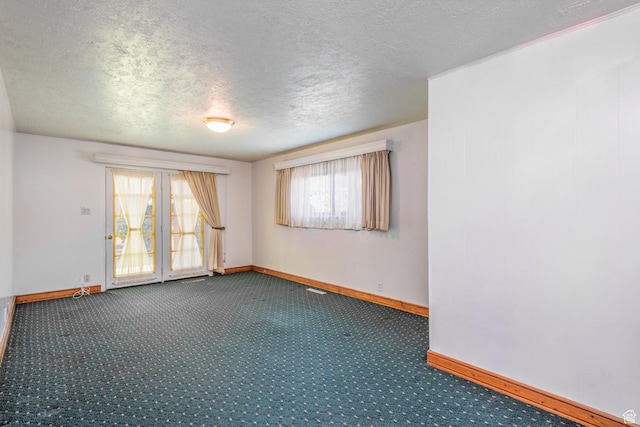 570 N Parkway Ave, Tooele, UT 84074 - carpeted empty room featuring baseboards, a textured ceiling, and plenty of natural light