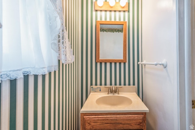 570 N Parkway Ave, Tooele, UT 84074 - bathroom featuring wallpapered walls and vanity