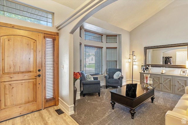 14263 S Morning Light Dr W, Herriman, UT 84065 - entryway featuring arched walkways, vaulted ceiling, wood finished floors, and baseboards