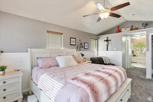 14263 S Morning Light Dr W, Herriman, UT 84065 - bedroom featuring dark colored carpet, vaulted ceiling, ensuite bath, wainscoting, and a ceiling fan