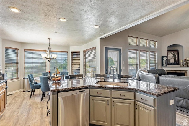 14263 S Morning Light Dr W, Herriman, UT 84065 - kitchen featuring dishwasher, a sink, open floor plan, light wood-style flooring, and an island with sink