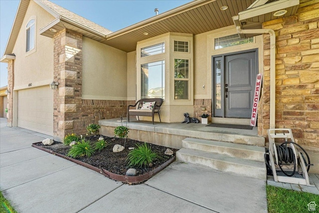 14263 S Morning Light Dr W, Herriman, UT 84065 - entrance to property featuring stucco siding, an attached garage, concrete driveway, and brick siding