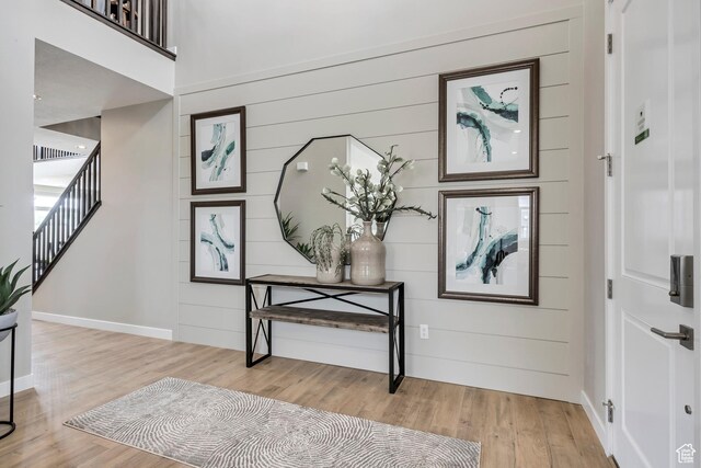 873 S 120 W Unit 003, American Fork, UT 84003 - entryway with light wood-style flooring, stairway, baseboards, and wooden walls