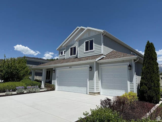 873 S 120 W Unit 003, American Fork, UT 84003 - view of front facade with concrete driveway, board and batten siding, a garage, and roof with shingles