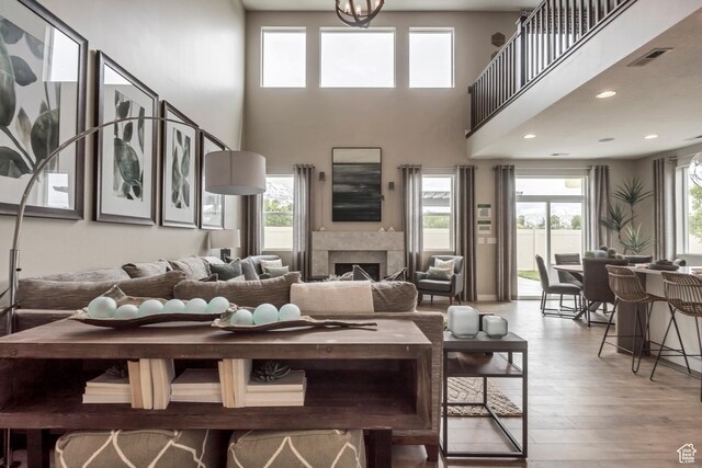873 S 120 W Unit 003, American Fork, UT 84003 - living area featuring wood finished floors, a high ceiling, and a fireplace