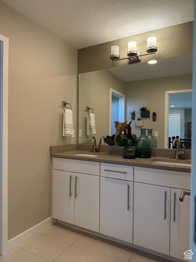 873 S 120 W Unit 003, American Fork, UT 84003 - bathroom featuring tile patterned flooring, double vanity, and baseboards