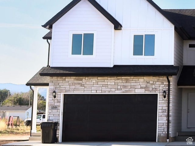 815 N 216 W Unit 23, Nephi, UT 84648 - view of front of property with stone siding, an attached garage, driveway, and board and batten siding