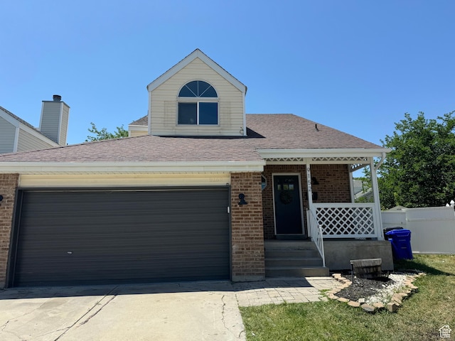 9152 S Cripple Creek Cir W, West Jordan, UT 84088 - view of front of house with brick siding, covered porch, concrete driveway, and roof with shingles