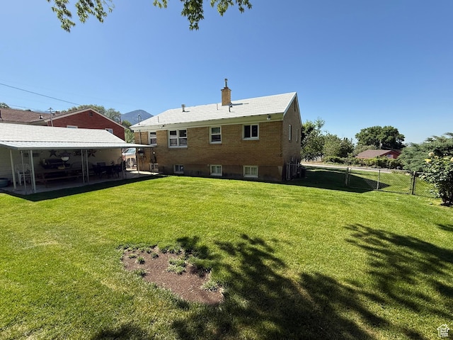 272 E 3000 N, North Ogden, UT 84414 - back of house featuring a chimney, a patio area, and brick siding