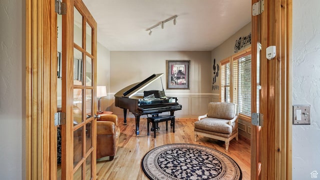 1988 Fieldstone Ln, Heber City, UT 84032 - living area featuring light wood finished floors, track lighting, french doors, and a wainscoted wall