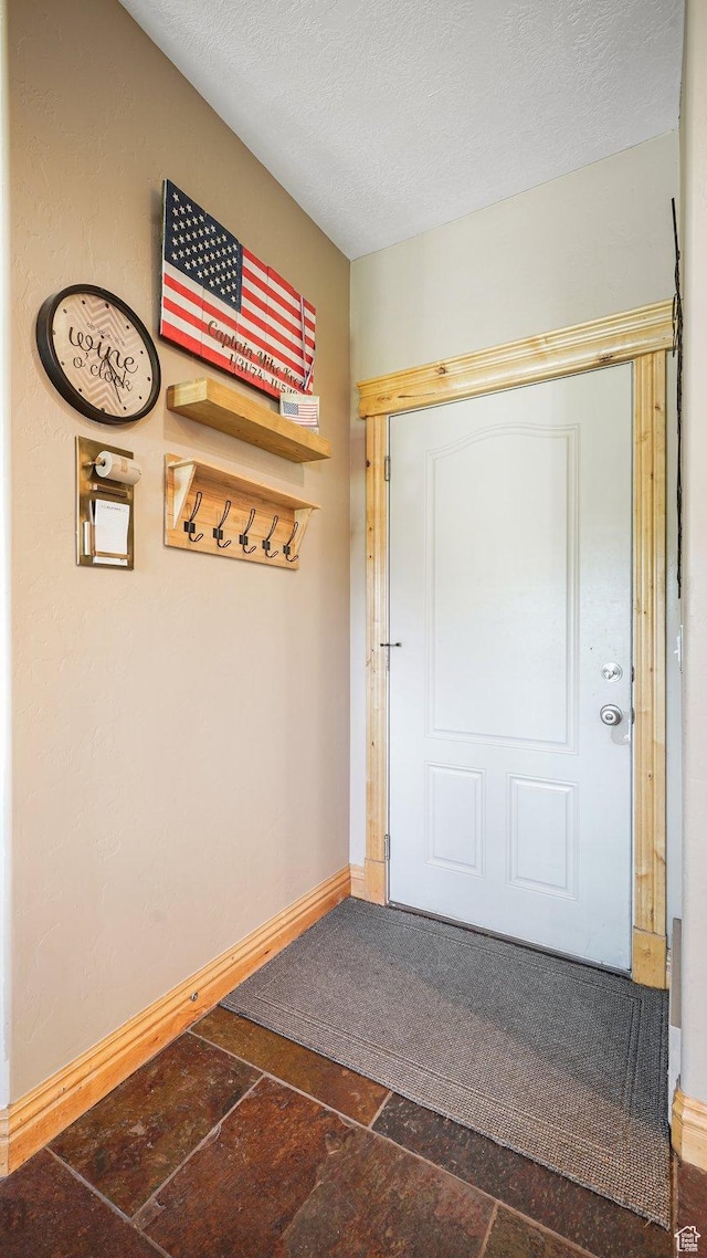 1988 Fieldstone Ln, Heber City, UT 84032 - entryway with stone tile flooring, baseboards, and a textured ceiling