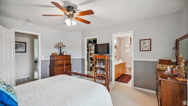 677 E 110 N, Heber City, UT 84032 - bedroom with light colored carpet, a walk in closet, ensuite bathroom, ceiling fan, and baseboards
