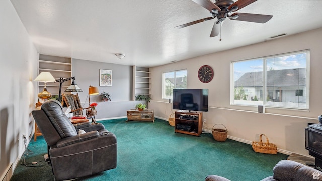 677 E 110 N, Heber City, UT 84032 - living area with carpet flooring, a wood stove, a textured ceiling, built in features, and ceiling fan
