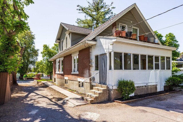 2269 S Green St Unit 1-4, Salt Lake City, UT 84106 - view of front of home featuring brick siding, entry steps, and a sunroom