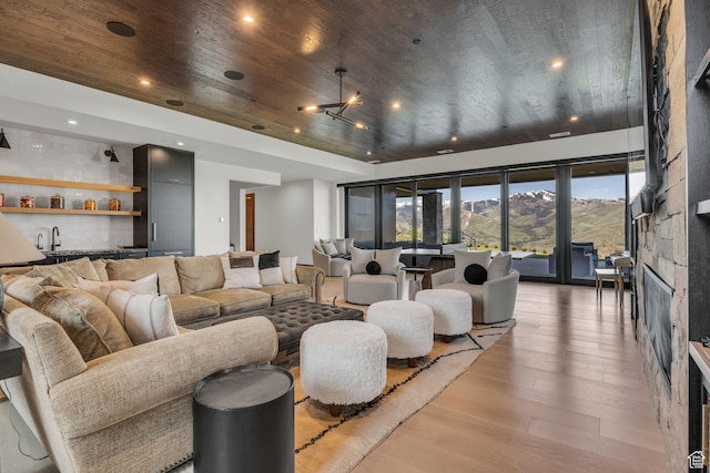 1735 Red Hawk Trl, Park City, UT 84098 - living area with wooden ceiling, light wood-type flooring, bar with sink, a stone fireplace, and recessed lighting