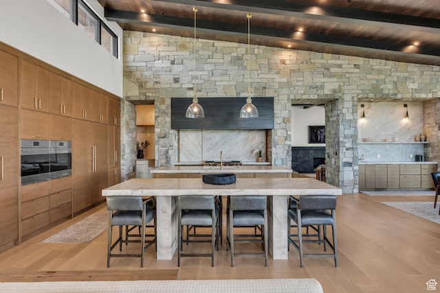 1735 Red Hawk Trl, Park City, UT 84098 - kitchen with a spacious island, light countertops, a breakfast bar area, wooden ceiling, and light wood-style floors