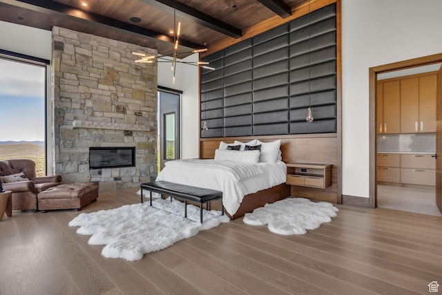 1735 Red Hawk Trl, Park City, UT 84098 - bedroom featuring wood finished floors, wood ceiling with exposed beams, and a stone fireplace