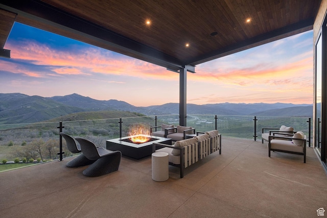 1735 Red Hawk Trl, Park City, UT 84098 - patio terrace at dusk with a mountain view, an outdoor living space with a fire pit, and a patio area
