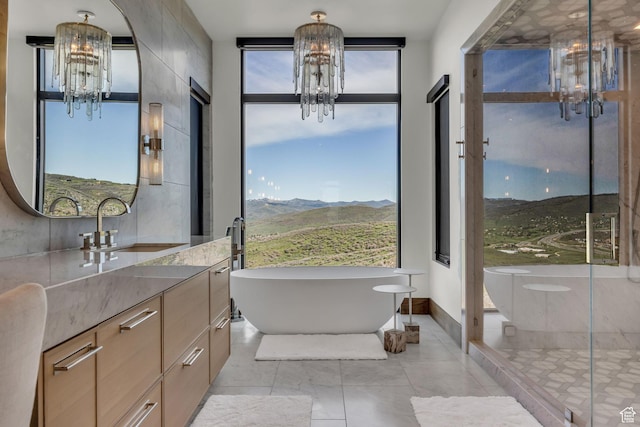 1735 Red Hawk Trl, Park City, UT 84098 - full bathroom featuring a chandelier, vanity, a freestanding tub, a mountain view, and a stall shower