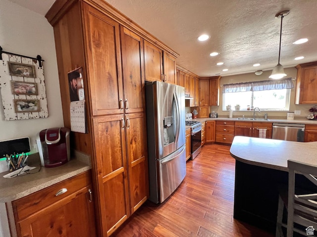 505 W 300 N, Orangeville, UT 84537 - kitchen featuring stainless steel appliances, a sink, brown cabinetry, recessed lighting, and wood finished floors
