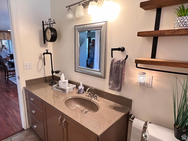 505 W 300 N, Orangeville, UT 84537 - bathroom with toilet, vanity, and wood finished floors