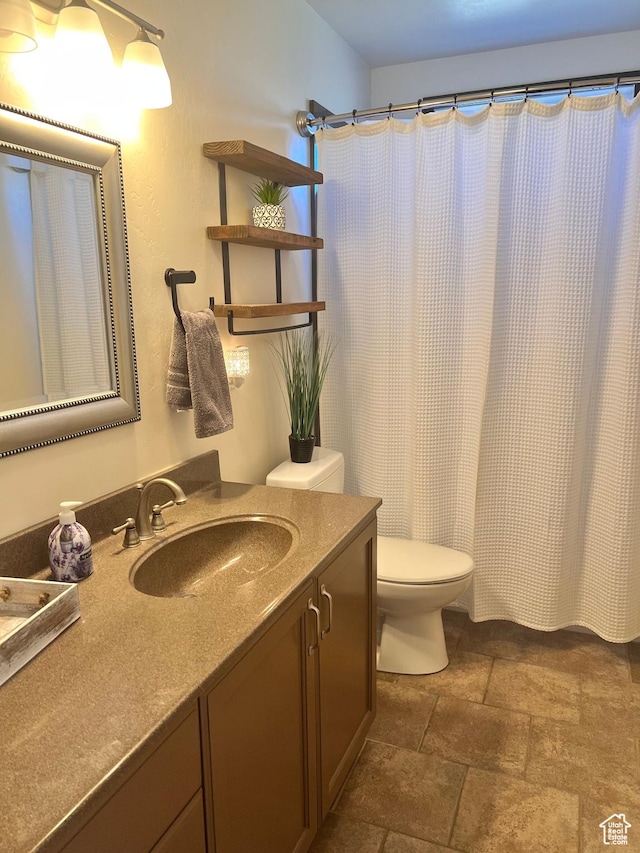 505 W 300 N, Orangeville, UT 84537 - full bath featuring stone tile floors, vanity, toilet, and curtained shower