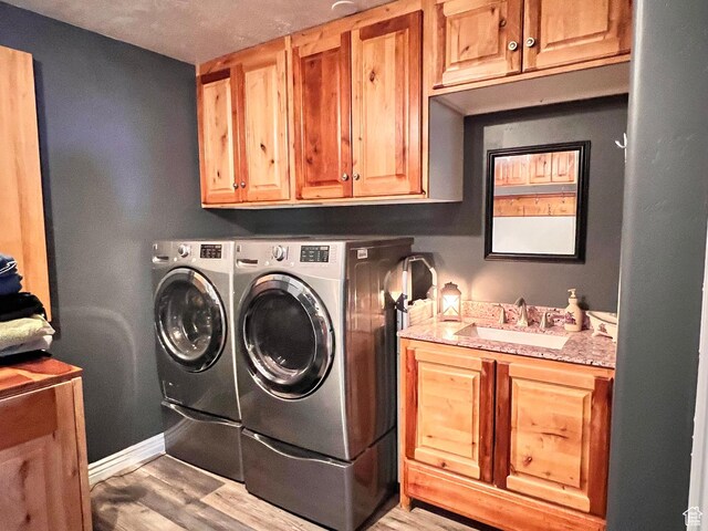 505 W 300 N, Orangeville, UT 84537 - laundry area featuring cabinet space, washing machine and dryer, and light wood-style flooring