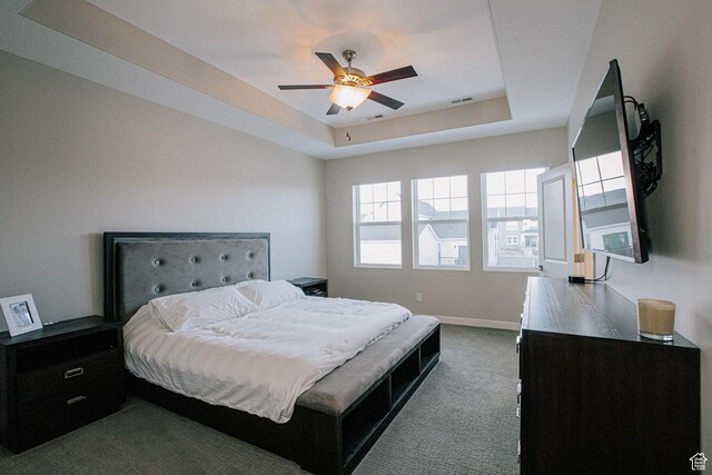 5028 W Lake Terrace Ave, South Jordan, UT 84009 - bedroom with dark colored carpet, a tray ceiling, baseboards, and a ceiling fan