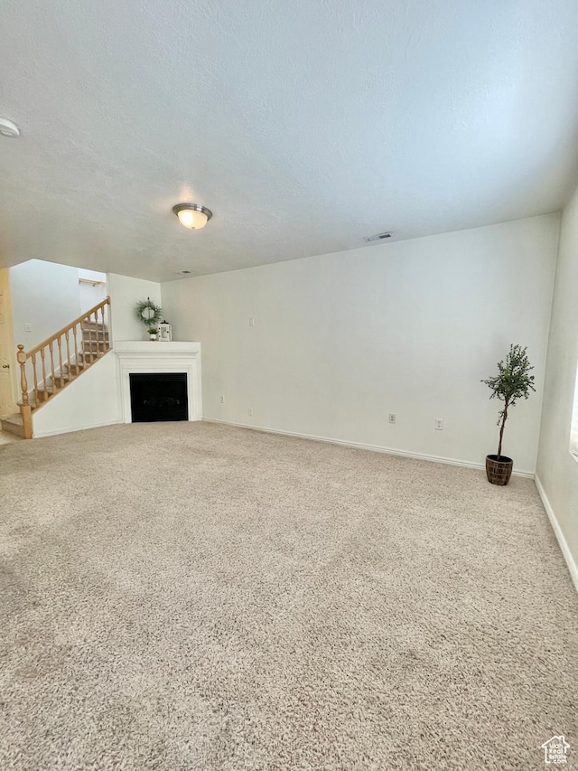 652 W 800 N Unit 112, Clinton, UT 84015 - unfurnished living room featuring a textured ceiling, carpet floors, and baseboards