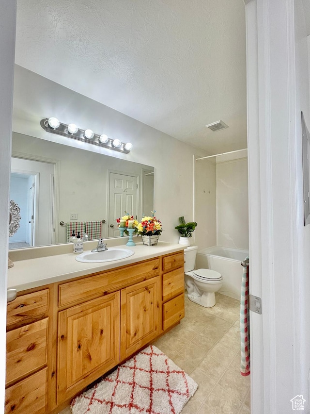 652 W 800 N Unit 112, Clinton, UT 84015 - bathroom featuring vanity, toilet, tile patterned flooring,  shower combination, and a textured ceiling
